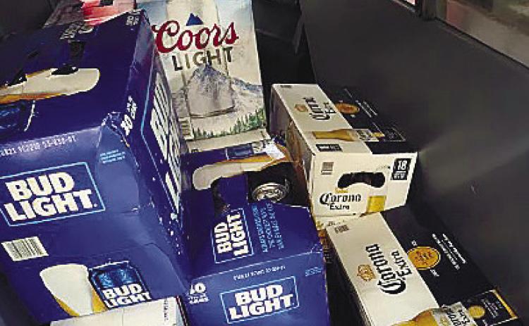 Cases of stolen beer are stacked in the back seat of the Camry involved in a police pursuit. The brews were returned safely to the grocery store. CONTRIBUTED