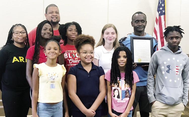 Coach Barry Havior (back row, right) poses with the Baldwin County Lightning Jets after receiving the proclamation for Coach Barry Havior Day from council member Denese Shinholster. GREENBERRY MOORE/Staff