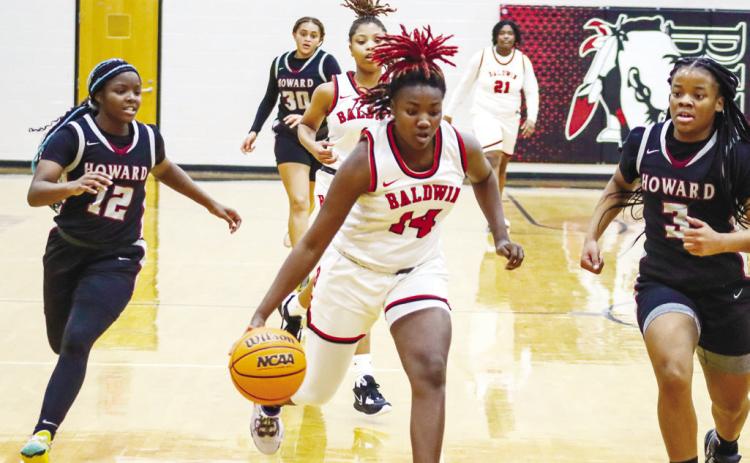 Zykeria Paschal (14) drives the lane in transition before a made layup. LANCE MCCURLEY/Staff