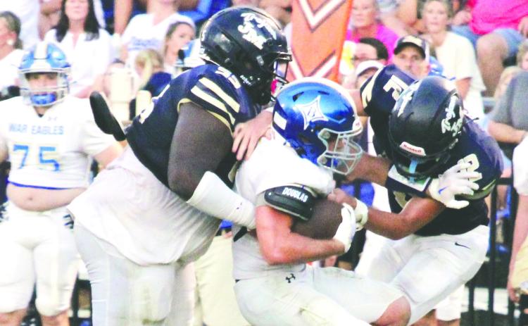 John Milledge Academy's Tyrecus Harrison (55) and David Todd (12) converge on a Brentwood ball carrier earlier this year. JMA participated in an invitational tournament at Columbus last Saturday. TREY NORRIS/Staff