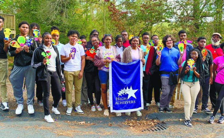 High Achievers participants pose with their hand-made light bulbs at Georgia College & State University’s east campus.