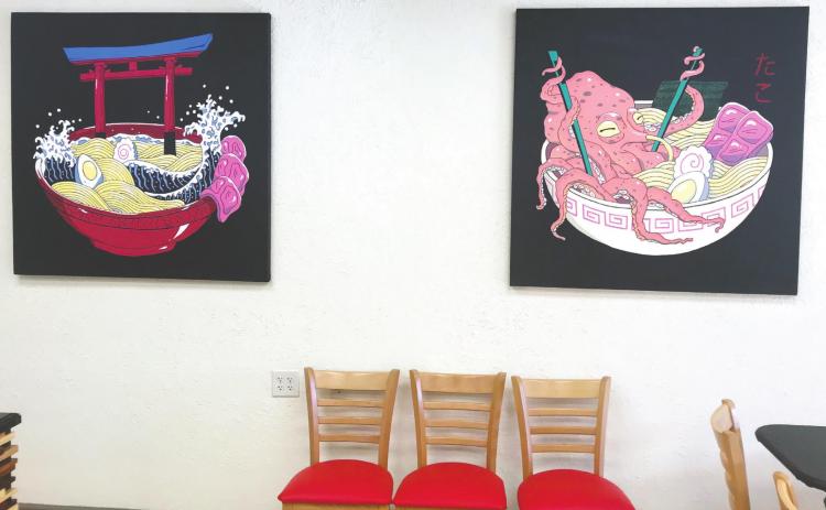 The inside of the restaurant features Asian-inspired artwork from an artist in the country of Trinidad and Tobago, whom McDade said graciously allowed her use. JOEL WHITE/Staff