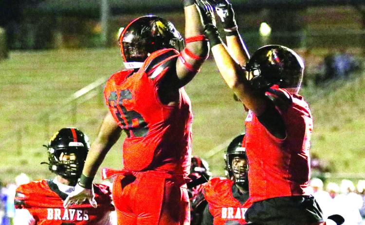 Baldwin’s Jonquavious “Q” Russell (36) and Jaylen King (right) celebrate with quarterback Lamar Pounds (8) and Dejanerio Hill (61) looking on after a touchdown. TREY NORRIS/Staff