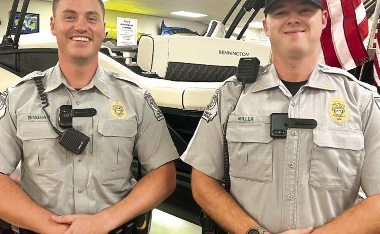 Georgia DNR Game Wardens Taylor Bingham (left) and Mason Miller conducted a safe boater class last month at Crowe Marine in Putnam County. IAN TOCHER/Staff