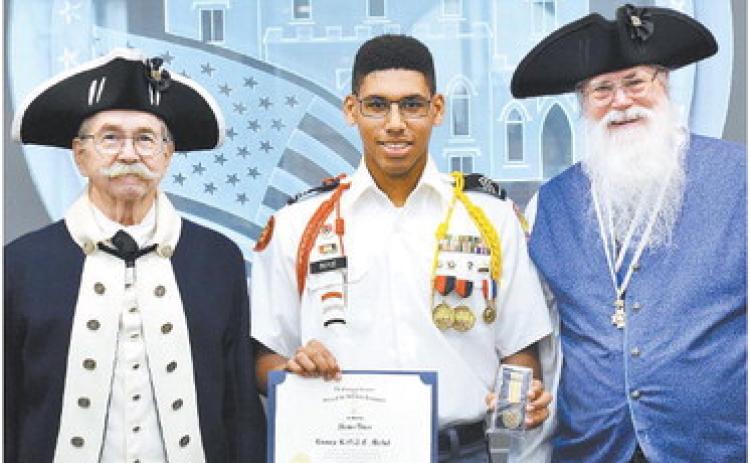 John Milledge Chapter President Terry Stair and Past President Jim Poyner present The SAR Bronze Medal to Georgia Military JRROTC Cadet Shawn Boyce. CONTRIBUTED