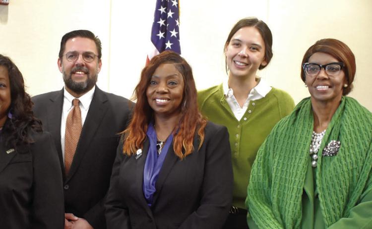 (L-R): Council Members Dr. Collinda Lee, Denese Shinholster, Dr. Jeffery Wells, Shonya Mapp, Morgan Pendergast, and Arlene Simmons are sworn in alongside Mayor Mary Parham-Copelan (front green). BAILEY BALLARD/Staff