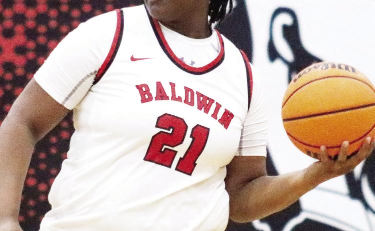 Baldwin junior Kassidy Neal (21) became the third player on the team to surpass 1,000 points this season. She reached the mark in a win over Griffin last week in the region championship game. LANCE McCURLEY/Staff