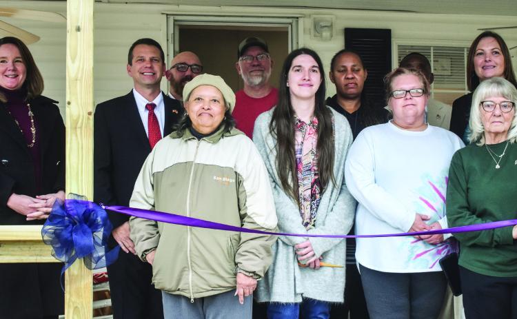Kayleigh Courson (center), Heather Schneider (center right), and Sonia Williams (right behind Courson) pose with the Baldwin County Board of Commissioners, the Ocmulgee Adult Treatment Court Collaborative, Ocmulgee Superior Court Judge Alison Burleson (far left) and Jeff Youman of Brighter Days Ministry(left behind Courson).