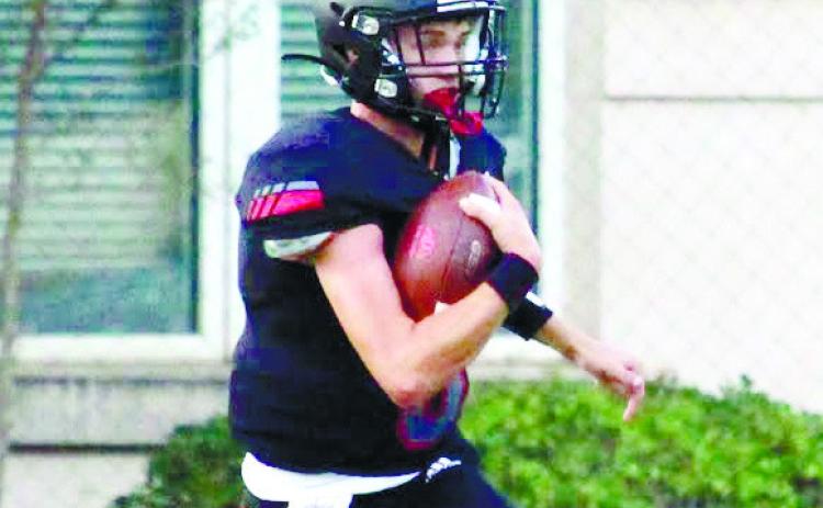 Logan McMillan scrambles for a first down against Wheeler County in the opener. TREY NORRIS/Staff