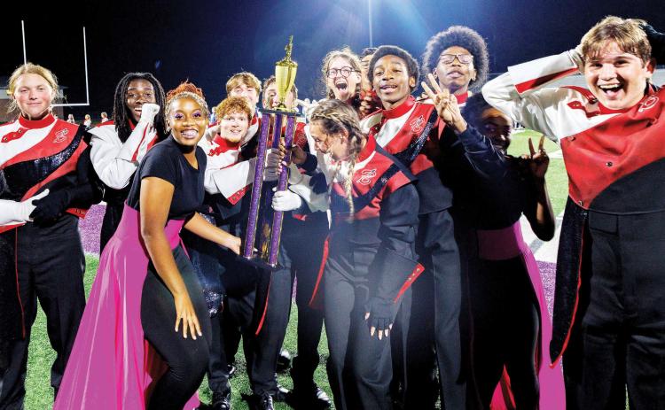 The Baldwin High School Band of the Braves celebrates being crowned as grand champion at the Hurricane Classic at Monroe Area High School. CONTRIBUTED
