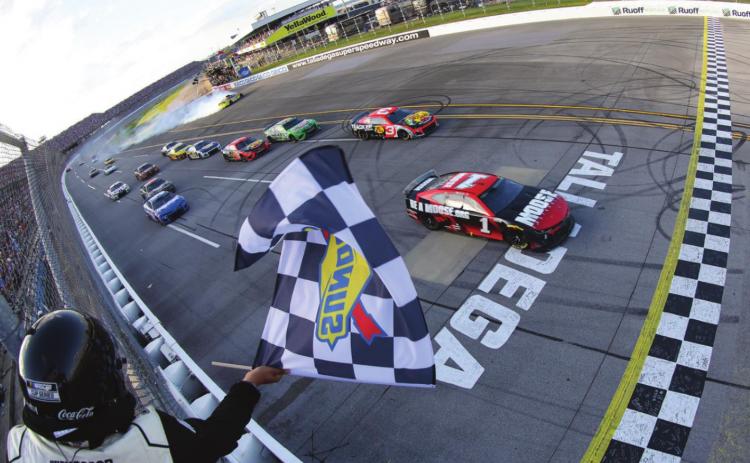 Ross Chastain, driver of the #1 Moose Fraternity Chevrolet, takes the checkered flag to win the Cup Series GEICO 500 at Talladega Superspeedway Sunday. (James Gilbert/Getty Images)