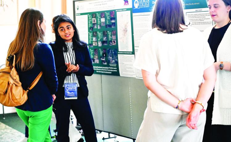 A student presents her research titled the “Impact of Urbanization and Land Connectivity on Scavenger B ehavior.” COURTESY OF GCSU
