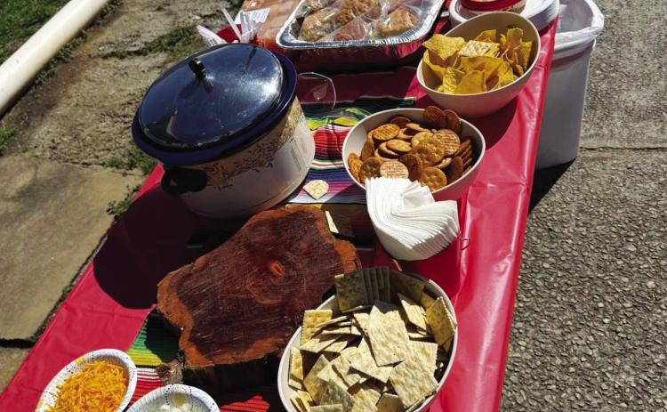 A chili contest entry alongside some sides and desserts. TY KARRAKER/Staff