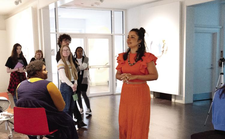 Brazilian artist Cândida Borges speaks to students and the public during opening night at the Transeunti Mundi Derive 01 exhibition in the Leland Gallery. CONTRIBUTED