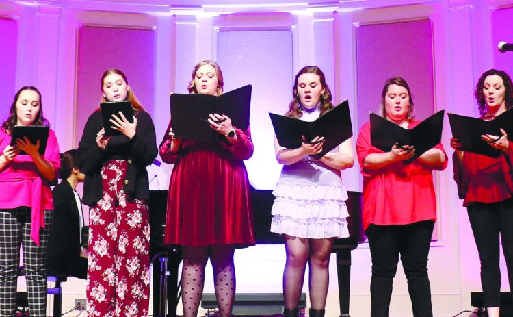 Female members of GCSU’s Max Noah Singers sing in harmony while dressed in Valentine’s Day themed clothing. CONTRIBUTED