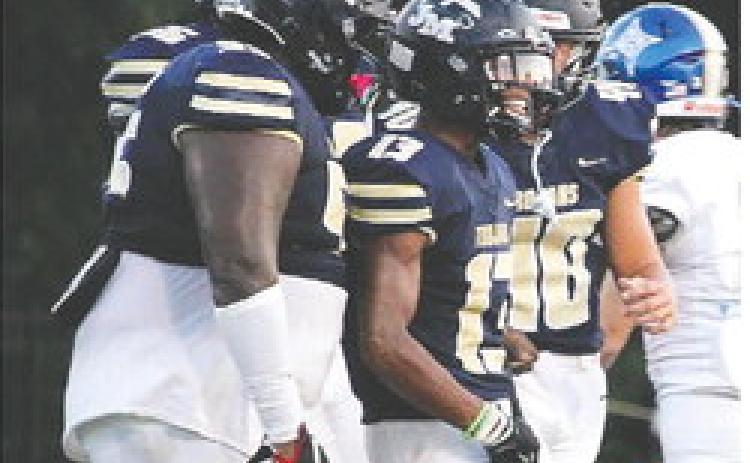 Jalen Butts (13) picked up a two-point conversion for the Trojans. TREY NORRIS/FILE PHOTO