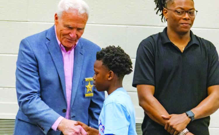 Sheriff Bill Massee shakes a student’s hand. CONTRIBUTED