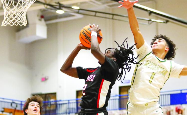 Karez Demory (2) goes up for a layup as a Wesleyan defender tries to block his shot. LANCE MCCURLEY/Staff
