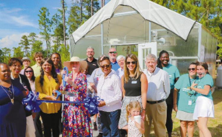 Attendees cut the ribbon to the new Aquaponics Lab. CONTRIBUTED
