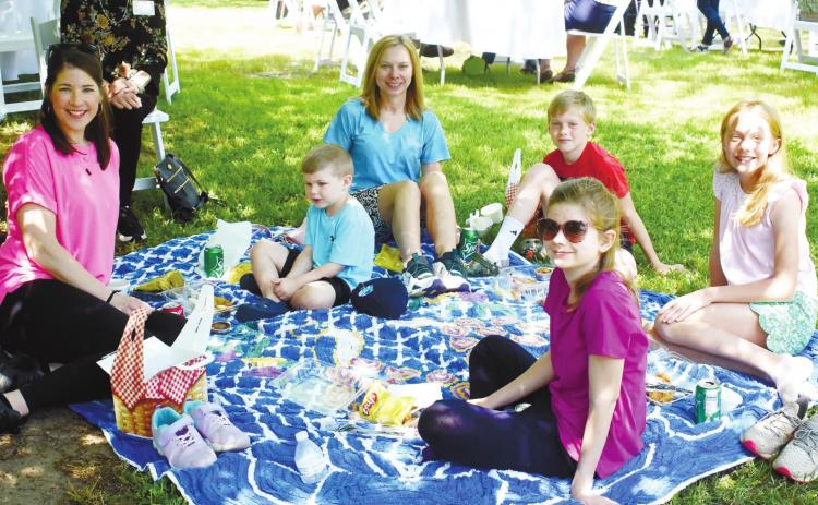 A family brings a blanket and has an authentic picnic lunch together on the Rockwell Mansion lawn. BAILEY BALLARD/Staff