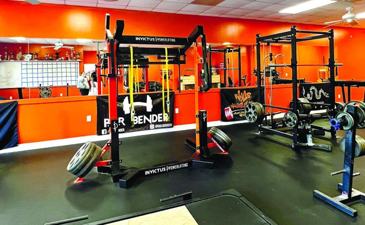 Heavy equipment for those who really enjoy testing their strength is set up in the back room of the gym.