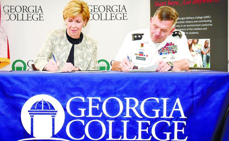 GCSU President Cathy Cox and GMC President William B. Caldwell IV sign the articulation agreement. CONTRIBUTED