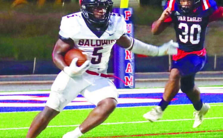 Baldwin running back Micah Welch (5) glides past defenders in against Putnam County earlier this season. LANCE MCCURLEY/Staff