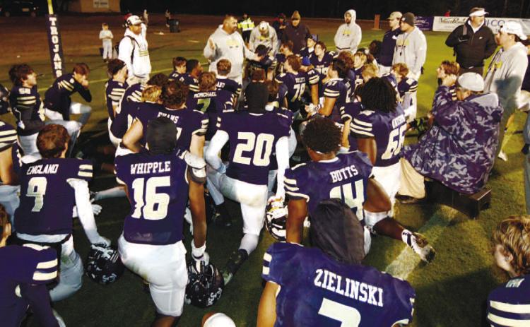 John Milledge Academy head coach J.T. Wall (center) addresses his team immediately following a 42-7 playoff victory that also set a new all-time Georgia high school football record of 48 straight wins. IAN TOCHER/Staff