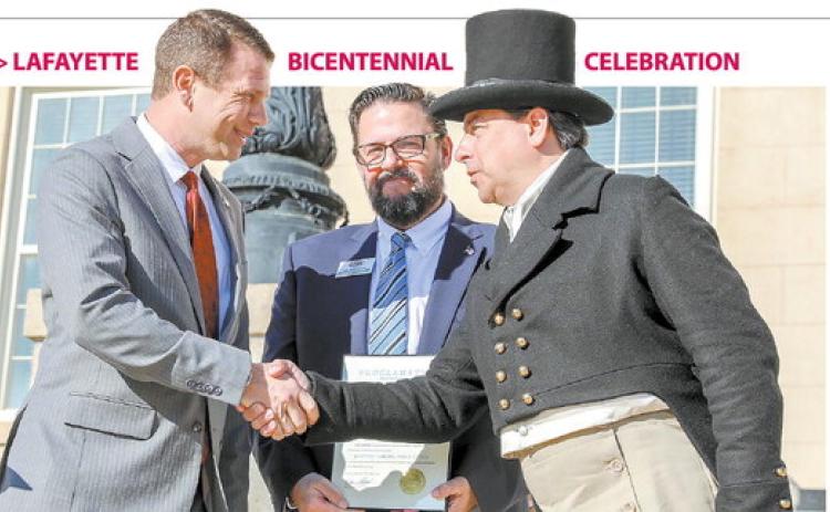 Baldwin County Board of Commissioners Chairman Andrew Strickland shakes hands with Lafayette re-enactor Charles Wissinger after reading the proclamation deeming March 26 “Lafayette’s Farewell Tour of Georgia” Day. CONTRIBUTED