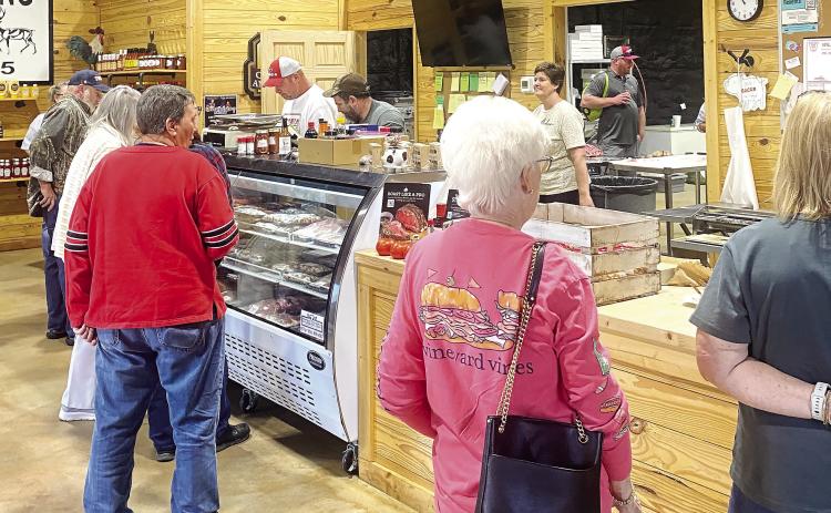 Customers stand in line to order meat inside C&amp;B Meat Market, the host of the festival. Their selection included samples of their finest meats, including hotdogs, hamburgers, sausages, and more. HANNAH MITCHELL/Staff