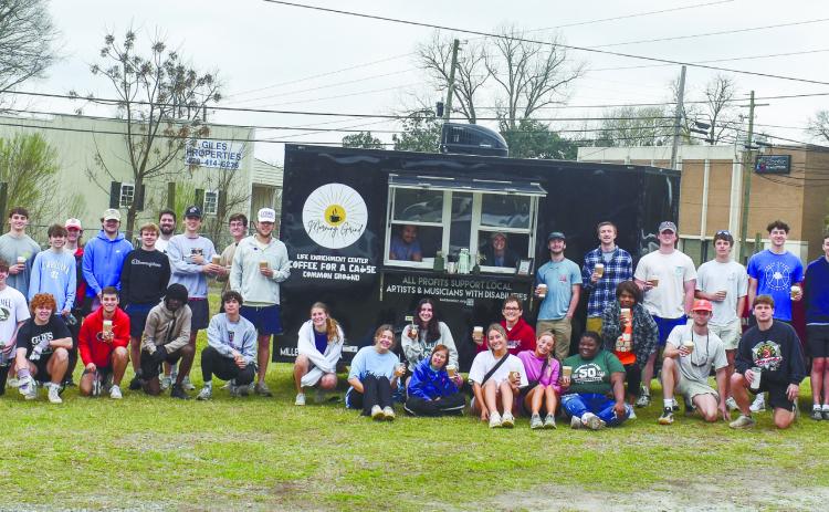 Participants, interns, staff and volunteers with the LEC alongside volunteers from Pi Kappa Alpha, Kappa Alpha Order, Phi Mu and New City Church stand in front of the LEC’s Coffee for a Cause coffee truck.