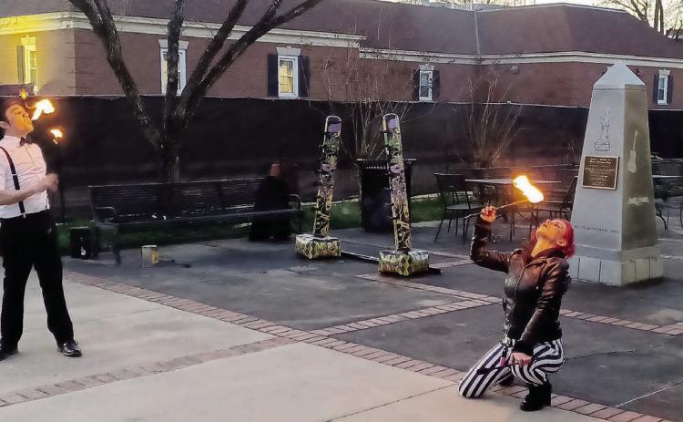 “Burnt Reynolds” and Kristin Wright from Strange Bedfellows put on a fire-breathing show with hula hoops, jump ropes, and batons in the Black Heritage Plaza beside Allen’s Market. Scan the QR code to see various events at Arti Gras.