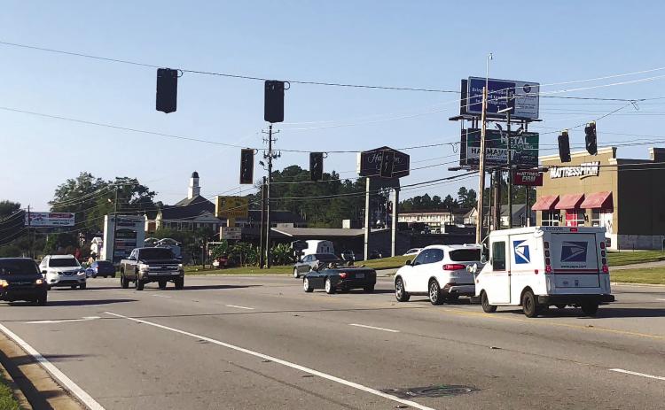 New traffic signals hang across North Columbia Street near the Milledgeville Mall, but they will not be activated until more engineering work is completed in the high-traffic area. GREENEBERRY MOORE/Staff