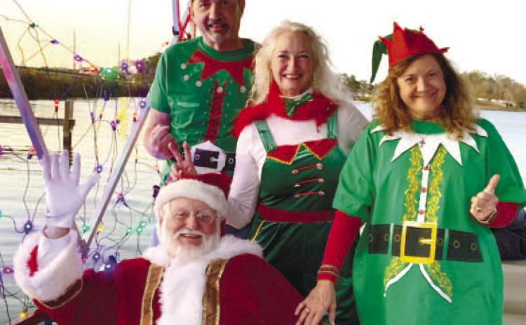 Santa and his elves pose on their cruise ship before it takes off toward Christmas Cove. BAILEY BALLARD/Staff