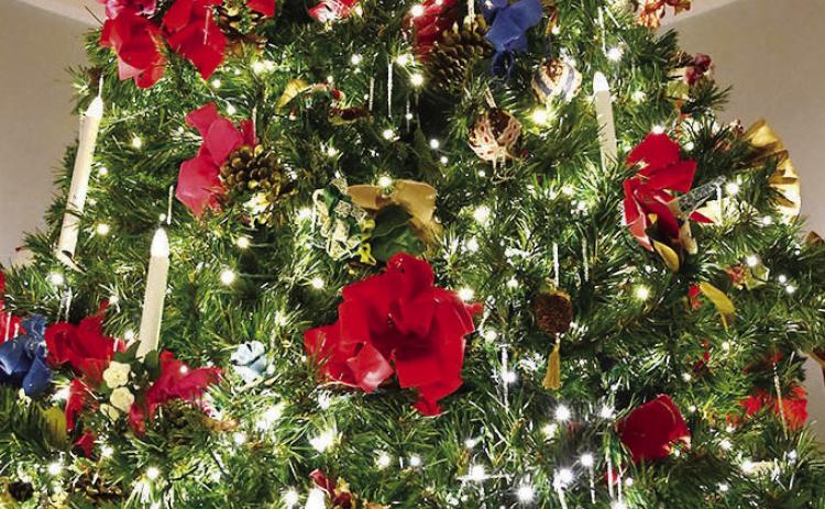 A 22-foot tall Christmas tree rises through the central rotunda in Georgia’s Old Governor’s Mansion. CAROLINE WOOD/GCSU