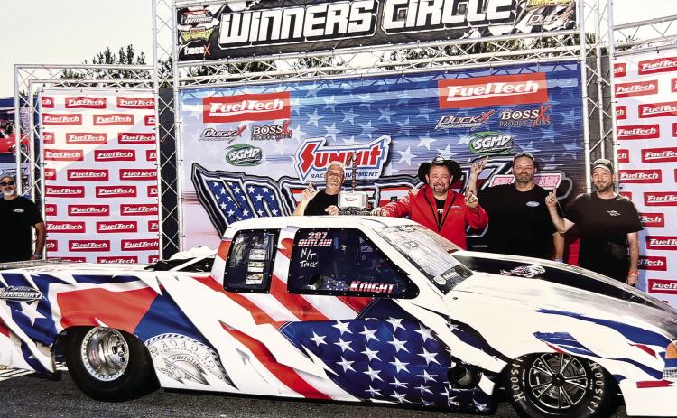 Eatonton-based racer C.G. Knight (center with hat) celebrates his No Mercy 15 win at South Georgia Motorsports Park with crewmembers Doug Colbert (left), Jason Mote, and Richard Disher. CHRIS SIMMONS/Contributed
