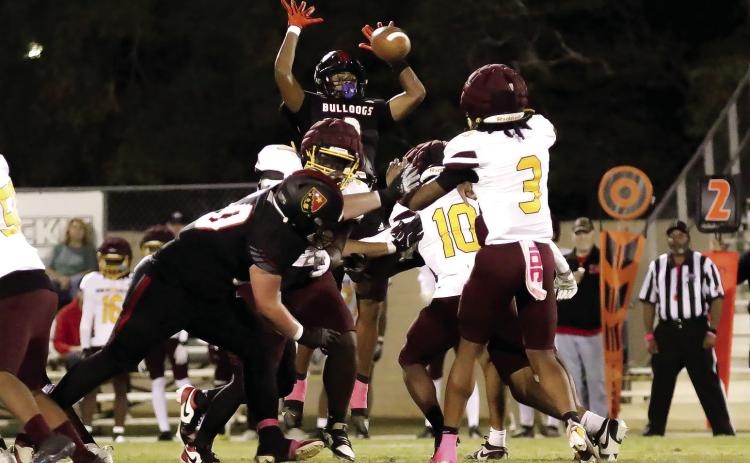 GMC senior Noah Yohan leaps up to block a Hancock Central passing attempt last Friday night in Milledgeville. TREY NORRIS/Staff