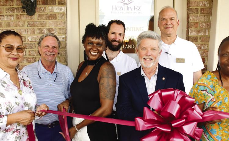 Latonya Taylor (third from left) prepares to cut the ribbon to officially open her Heal In-Ez Reiki &amp; Wellness Spa Aug. 5, in a ceremony hosted by the Eatonton-Putnam Chamber of Commerce. IAN TOCHER/Staff