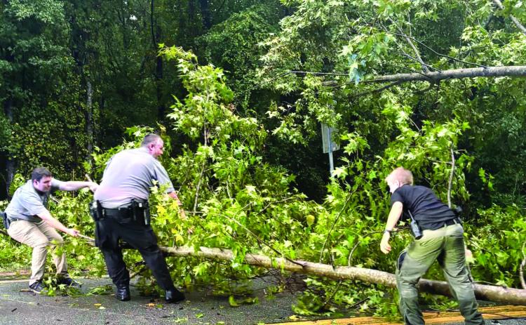 Officers with the Baldwin County Sheriff’s office were on the roadway removing trees and debris to make roads passable after Helene passed through. COURTESY OF BALDWIN SHERIFF GEORGIA FACEBOOK 