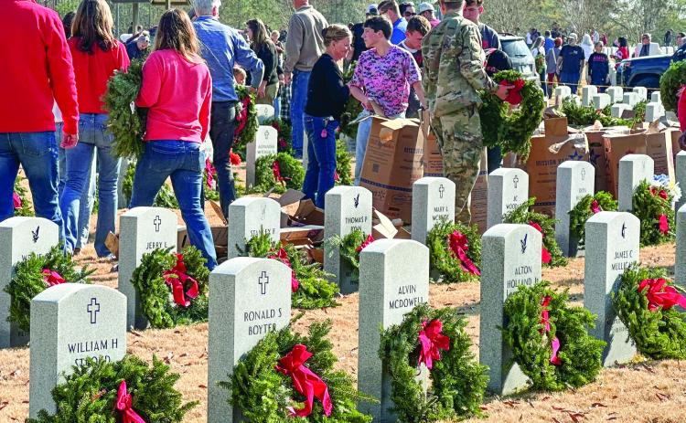 Wreaths lay on the head stones to honor veterans at the Georgia Veterans Memorial Cemetery. The theme of this year’s event was “Keep Moving Forward,” a sentiment Tanasia Hall, daughter of Carroll Hall, has carried with her since her father’s passing in 2023. Her father is buried in the cemetery. ALIVIA BLANTON/Staff