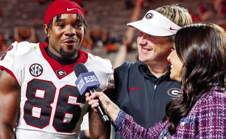 Sophomore wide receiver Dillon Bell threw a touchdown pass, caught five passes for 90 yards and a score while also recording one rush against Tennessee in Knoxville Saturday. Head coach Kirby Smart looks on with a smile during Bell’s post-game interview. COURTESY OF UGA ATHLETICS