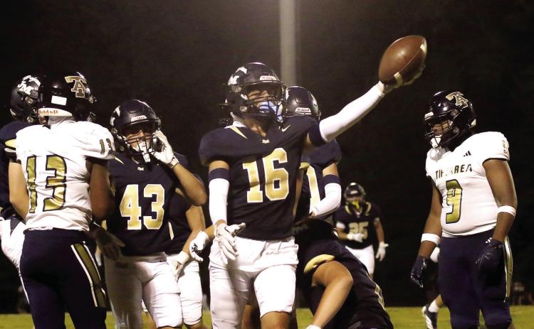John Milledge Academy’s Bradyn Harrison (16) celebrates an interception in a game played earlier this season in Milledgeville. TREY NORRIS/FILE PHOTO