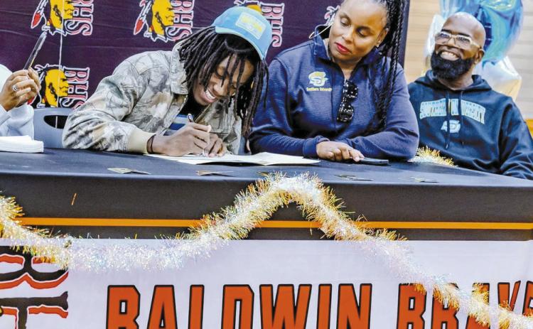 Karez Demory signs his national letter of intent to play basketball at Southern University. CONTRIBUTED