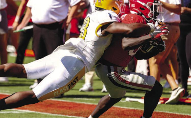 Georgia running back Daijun Edwards (30) drags a defender on his way to racking up 73 rushing yards and nine receiving yards against Kent State. KAYLA RENIE/UGA Athletics