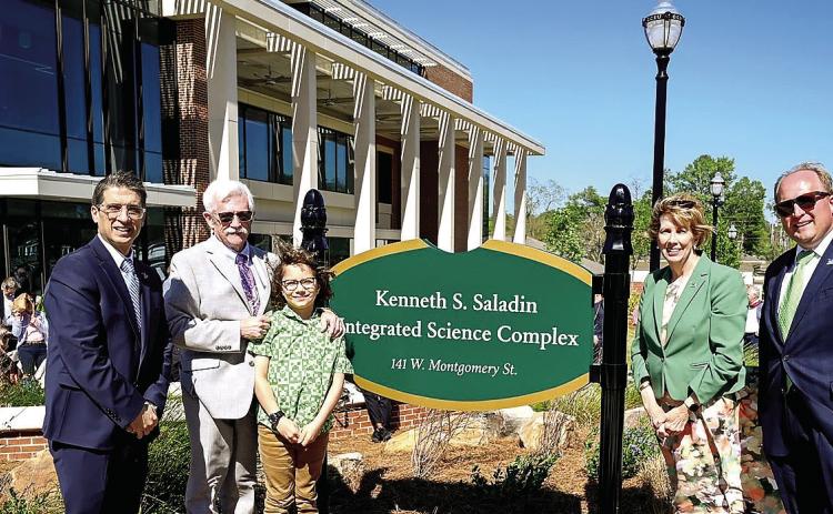 From left: Provost Dr. Costas Spirou, Dr. Kenneth Saladin with his grandson, GCSU President Cathy Cox and Vice President of University Advancement Seth Walker stand by the new sign for the Kenneth S. Saladin Integrated Science Complex. COURTESY OF GCSU
