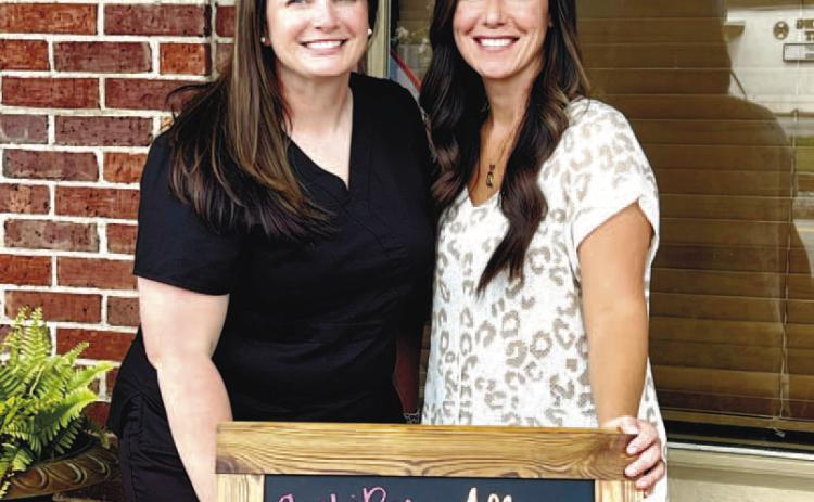 Anndrea Lampkin and Amber Asbell pose for a photo outside of Ambi Rae Boutique and Allure Beauty Bar.