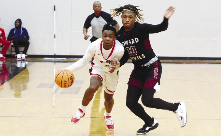 Jordan Webb (2) drives toward the basket against pressure from the Howard Huskies.