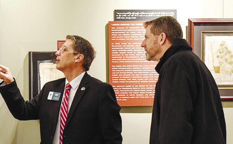 GCSU Provost Costas Spirou and Arts and Sciences Dean Eric G. Tenbus view the “To Be Uninvited Guests” exhibit on display in the Rare Book Room galleries of the Ina Dillard Russell Library. CONTRIBUTED