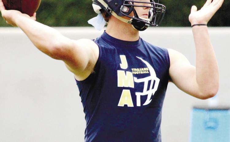 Junior quarterback Kolt McMichael will guide the offense for the Trojans this season, his first as a starter for the four-time defending GIAA 4-A state champions. TREY NORRIS/Staff