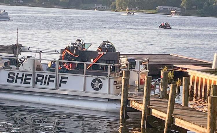 Searchers and divers on the Baldwin County Sheriff’s Office boat return to the command post for a break Friday. LYNN HOBBS/Staff